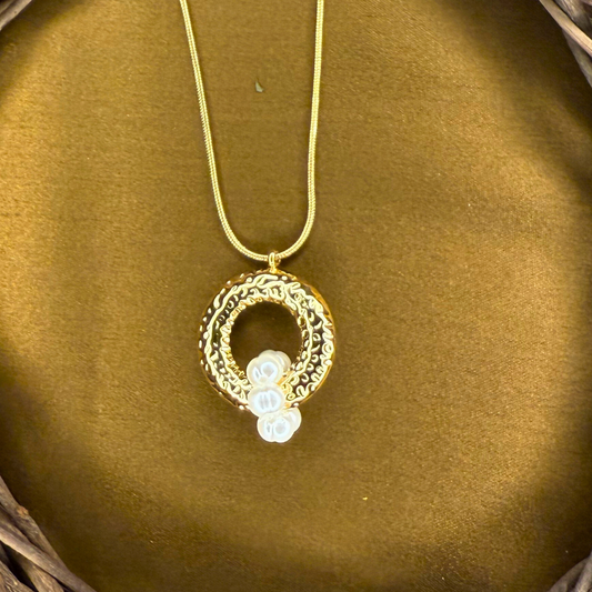 Oceara - A golden swirl cradling a pearl inspired by tides and eternal cycles of renewal.