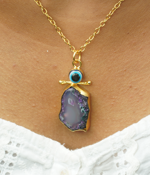Emberline – A sleek brass chain adorned with a delicate evil eye charm, timeless and symbolic